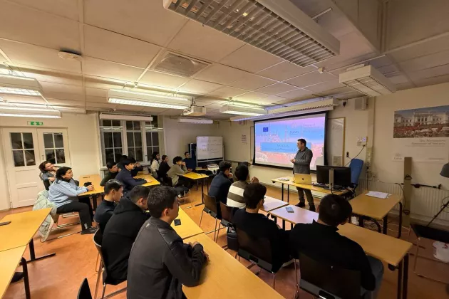 high school students sitting in a room, presentation, screen, desks