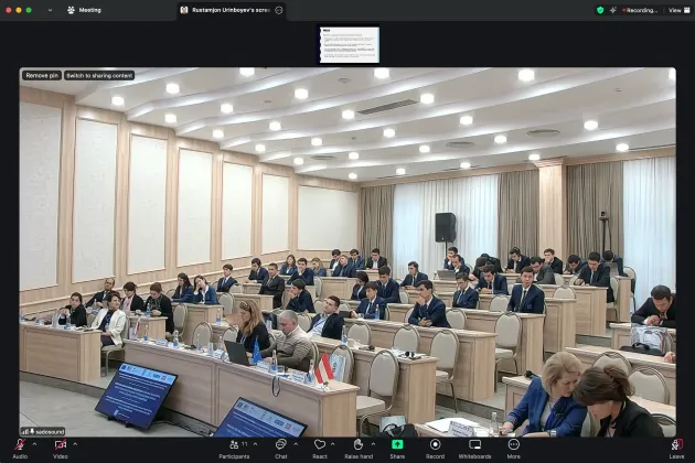 Audience listening to a conference presentation